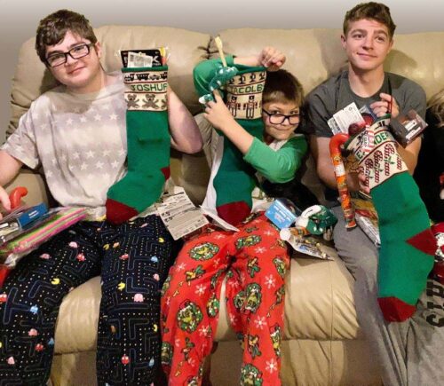 3 boys with christmas stockings 3 boys with christmas stockings